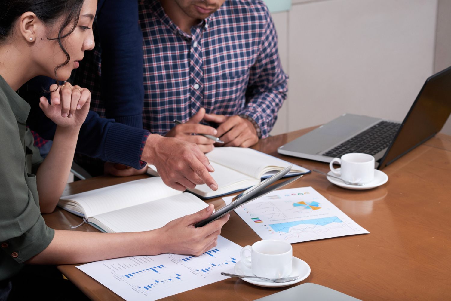 Team reviewing charts and reports at a table