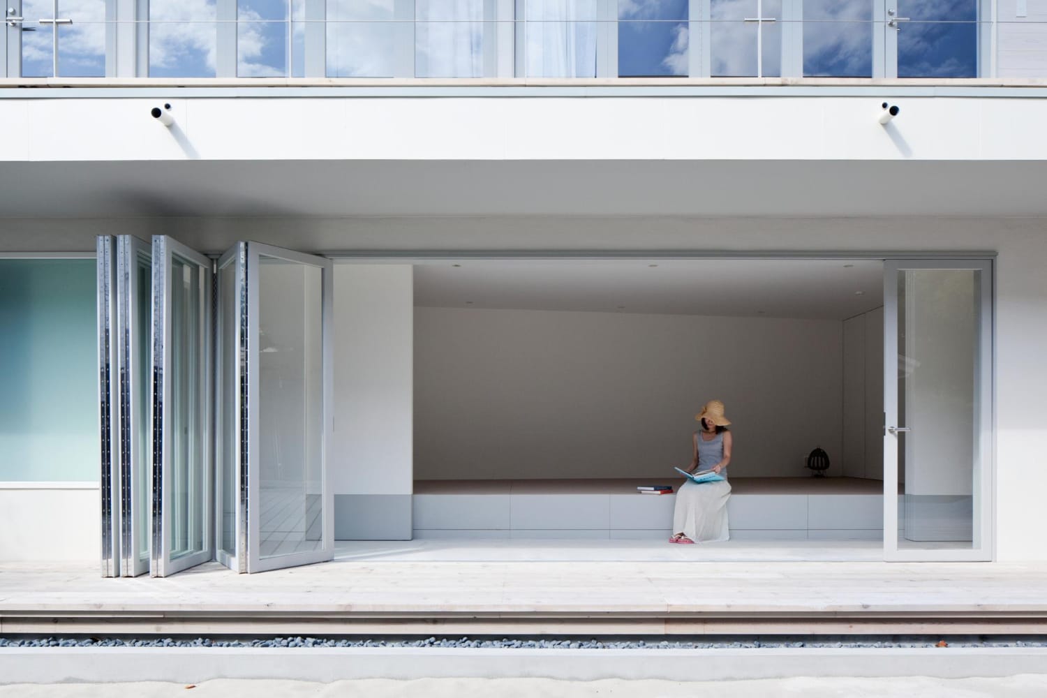 Glass door panels folded to one side of a wide opening