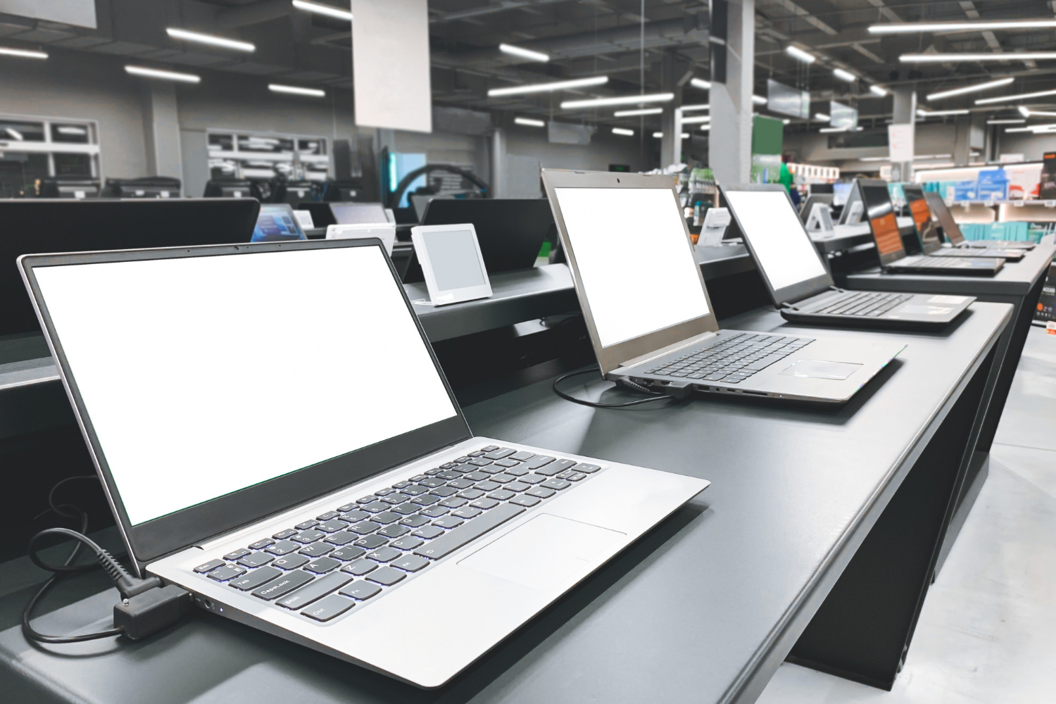 Laptops displayed for comparison in a computer retail store