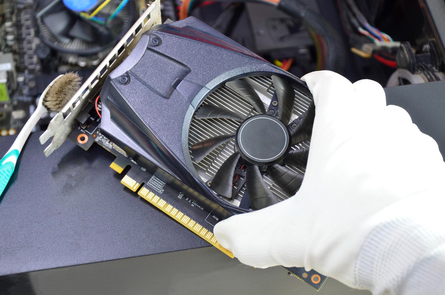 Graphics cooling fan being inspected during computer maintenance