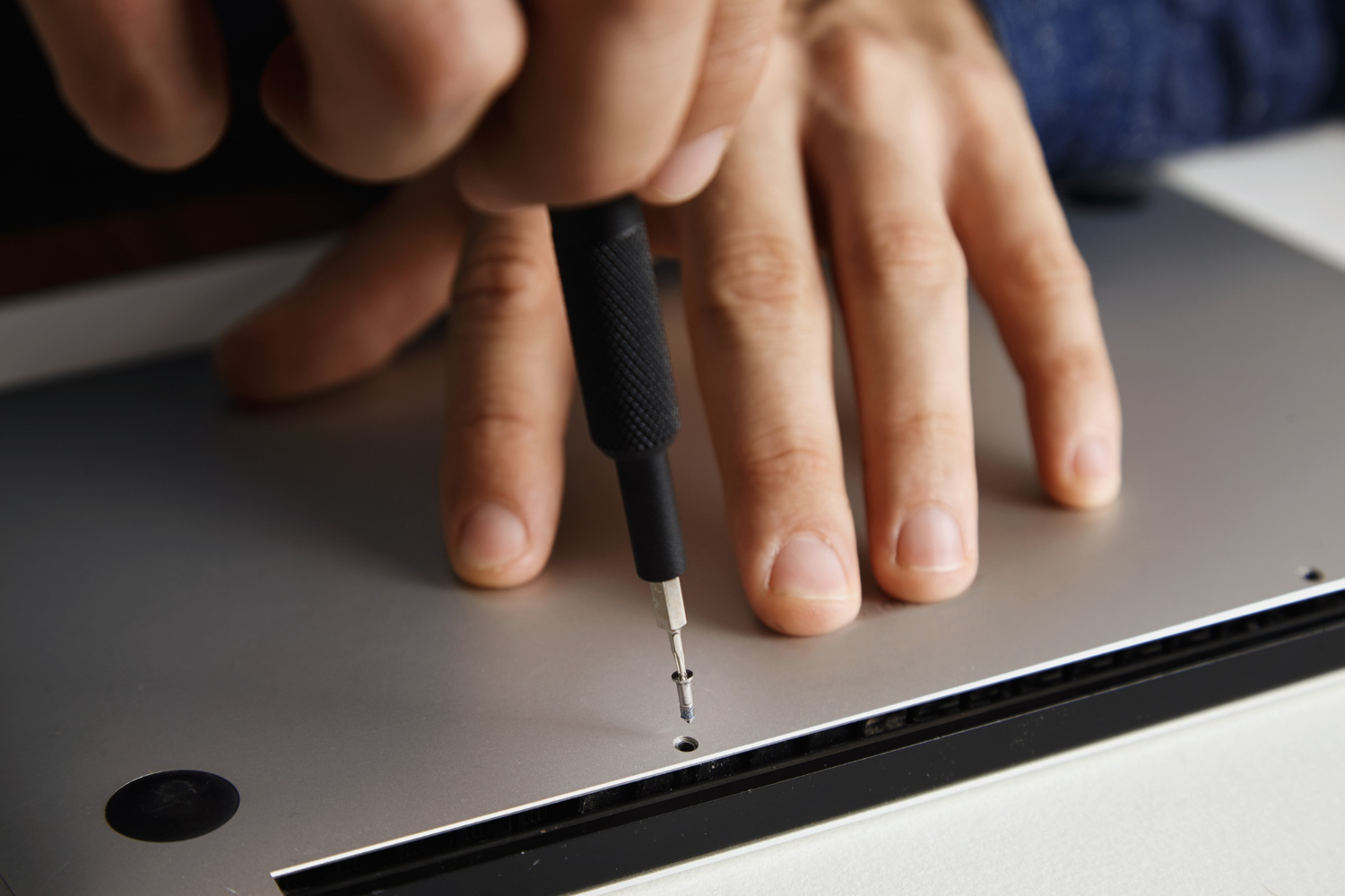 Buyer inspecting a used gaming laptop before purchase in Malaysia